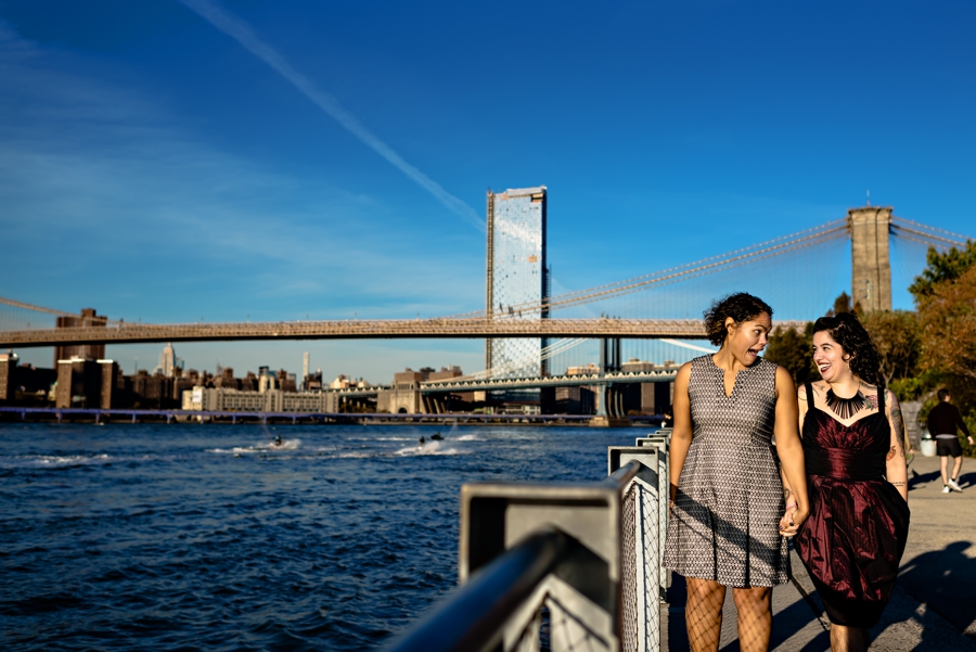 A same sex couple walk along the promenade in Brooklyn, NY where they got engaged.